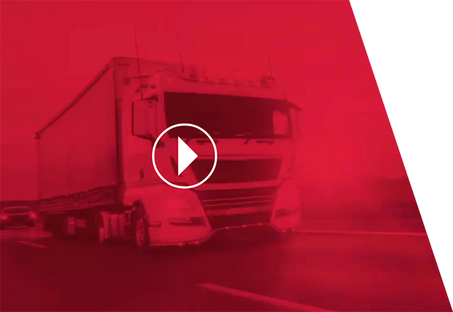 Faded image of a truck in a road under red lights